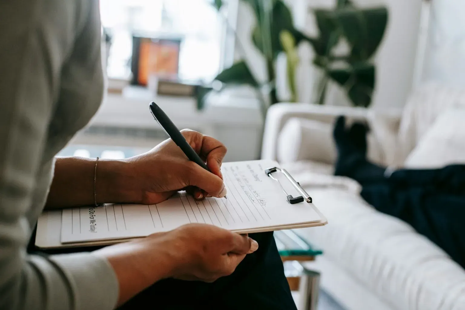 Person completing therapy exercises on a clipboard